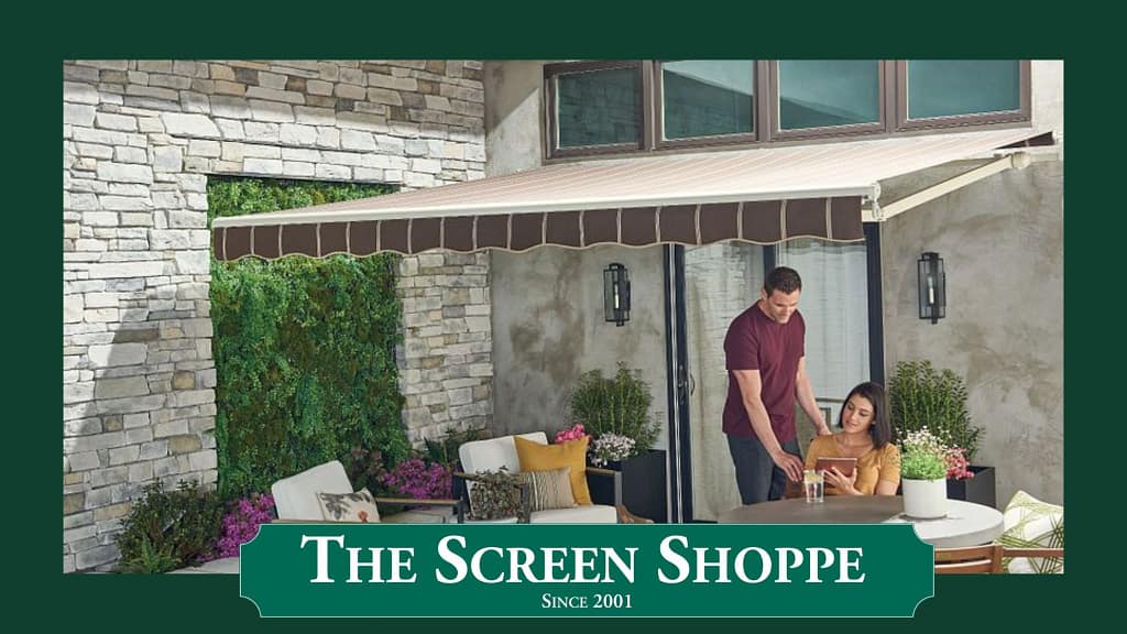 A couple enjoys their patio beneath the shade of a Sunsetter awning.