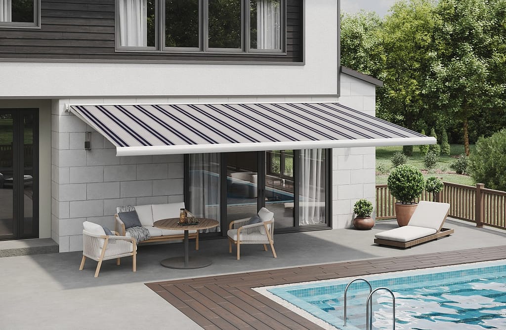 An extended retractable awning provides shade over a poolside patio.