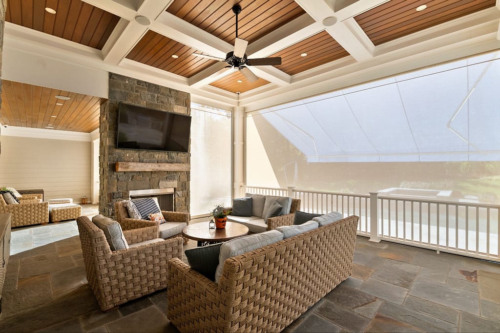 A porch filled with natural light, but still protected by a retractable awning as well as a retractable screen.