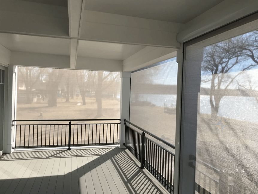 A lakeside summer home screened-in porch, allowing in natural light while keeping the outdoor space cool.
